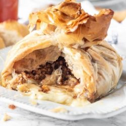 Baklava baked brie on a white plate