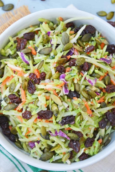This Crunchy Broccoli Slaw Salad is made with a bagged broccoli slaw and a few extra ingredients for a quick, easy and tasty side salad! #broccolislaw #broccolisalad www.savoryexperiments.com