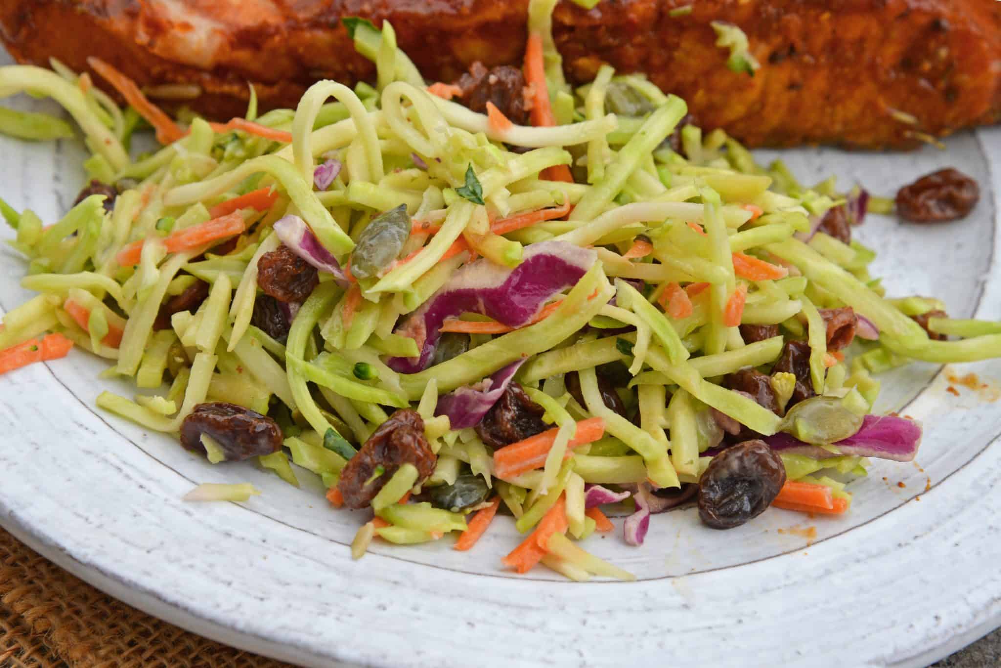 This Crunchy Broccoli Slaw Salad is made with a bagged broccoli slaw and a few extra ingredients for a quick, easy and tasty side salad! #broccolislaw #broccolisalad www.savoryexperiments.com