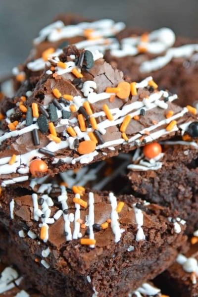 Halloween Brownies are a quick and easy Halloween themed dessert made with box brownie mix, cookie icing and sprinkles. An easy Halloween dessert! #halloweenbrownies #halloweenthemeddesserts #browniemix www.savoryexperiments.com