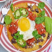 Huevos Rancheros are a great way to spice up your breakfast. Lacey eggs with a runny yolk over warm corn tortillas, chunky salsa, black beans, cilantro and queso fresco. #huevosrancheros www.savoryexperiments.com