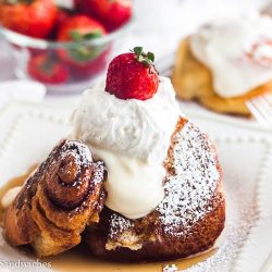 Cinnamon roll french toast with whipped cream and berries