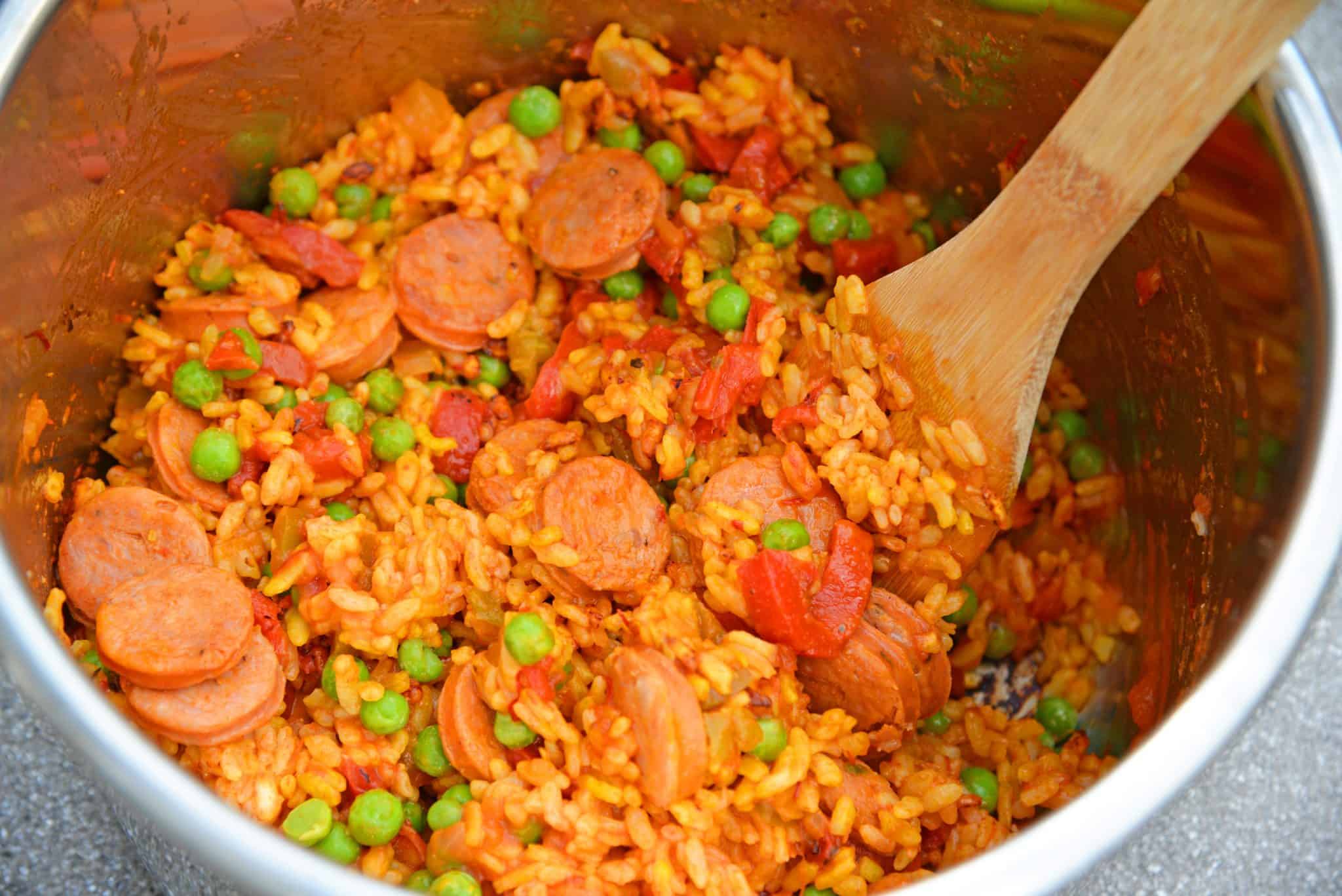 Instant Pot Chicken Paella is based off the traditional Spanish dish. Flavorful & ready in just minutes, this will be your go-to chicken and rice recipe. #chickenpaella #instantpotchickenrecipes #chickenandricerecipe www.savoryexperiments.com