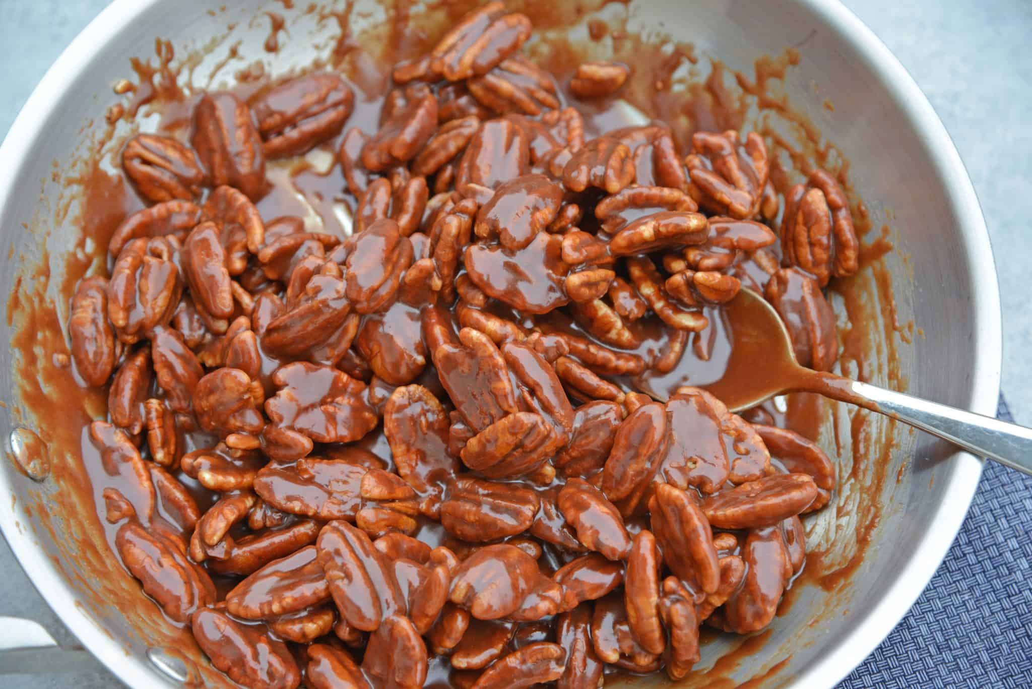 Pecan Pie Cheesecake is the perfect combination of two classic desserts - chocolate pecan pie and cheesecake. You'll want this on your holiday dessert menu! #chocolatepecanpie #pecanpiecheesecake #bestcheesecakerecipe www.savoryexperiments.com