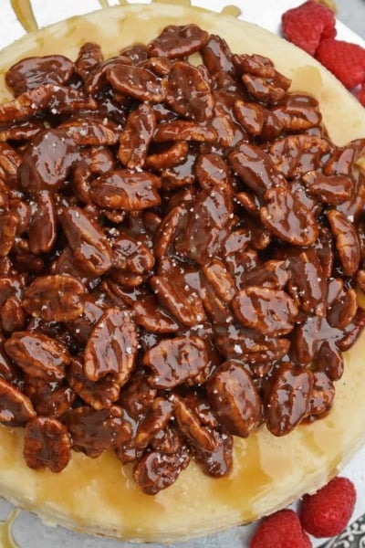 Pecan Pie Cheesecake is the perfect combination of two classic desserts - chocolate pecan pie and cheesecake. You'll want this on your holiday dessert menu! #chocolatepecanpie #pecanpiecheesecake #bestcheesecakerecipe www.savoryexperiments.com