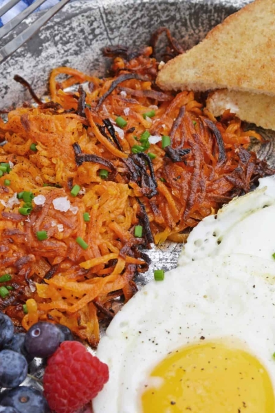 Sweet Potato Hash Browns are a simple breakfast recipe made with shredded sweet potatoes. Only 3 ingredients and a few minutes to cook! #sweetpotatohashbrowns #shreddedsweetpotatoes www.savoryexperiments.com