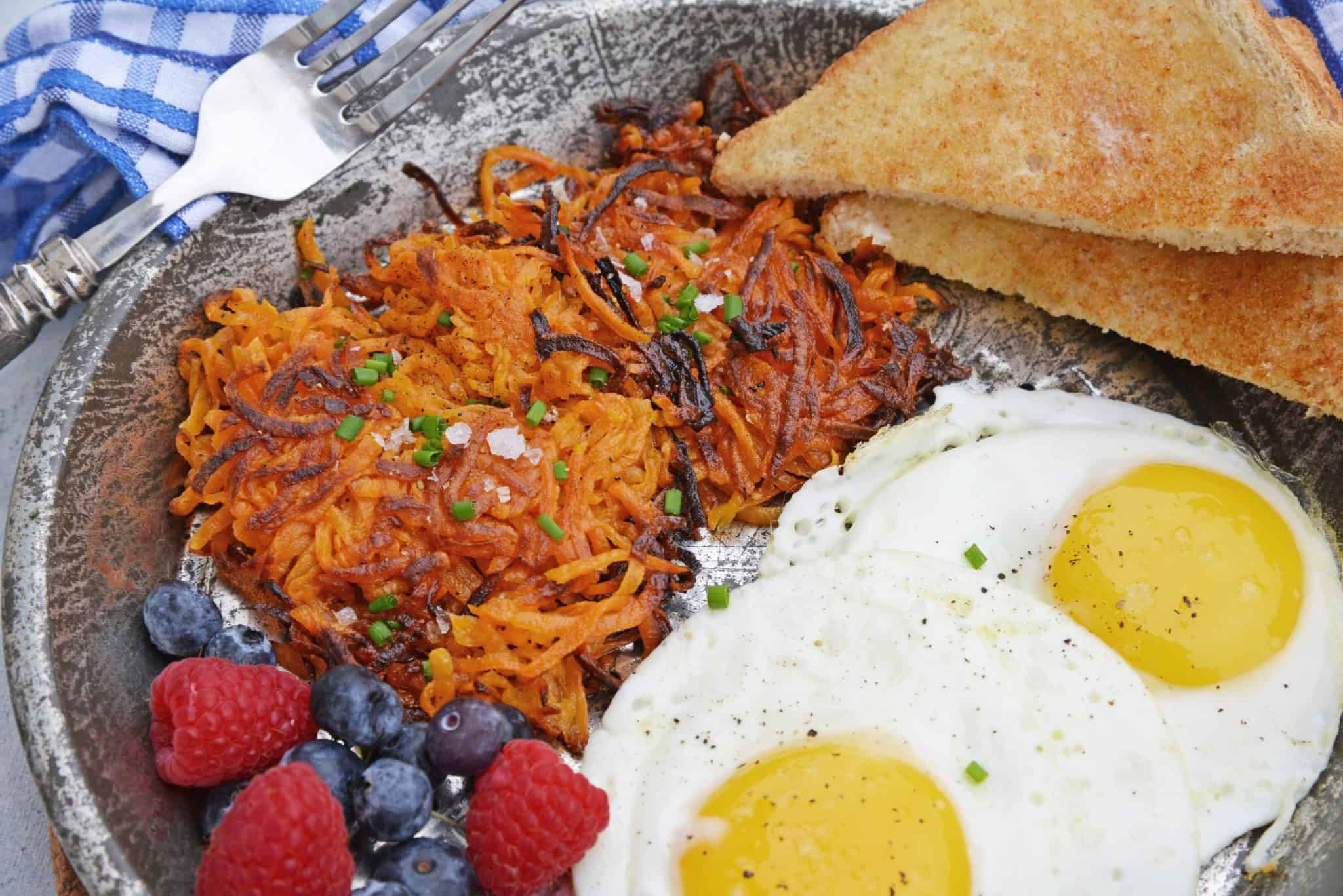Sweet Potato Hash Browns are a simple breakfast recipe made with shredded sweet potatoes. Only 3 ingredients and a few minutes to cook! #sweetpotatohashbrowns #shreddedsweetpotatoes www.savoryexperiments.com