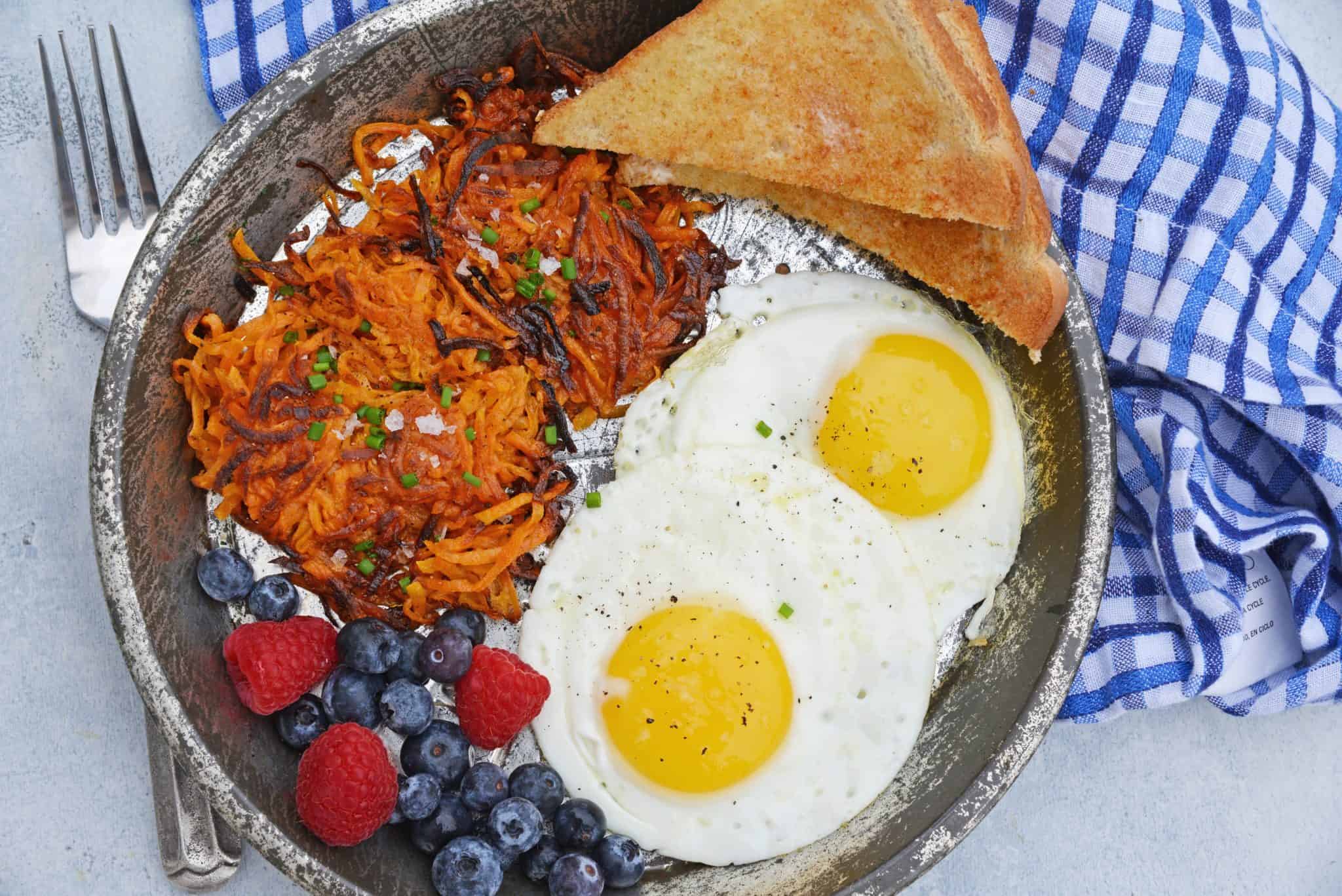 Sweet Potato Hash Browns are a simple breakfast recipe made with shredded sweet potatoes. Only 3 ingredients and a few minutes to cook! #sweetpotatohashbrowns #shreddedsweetpotatoes www.savoryexperiments.com