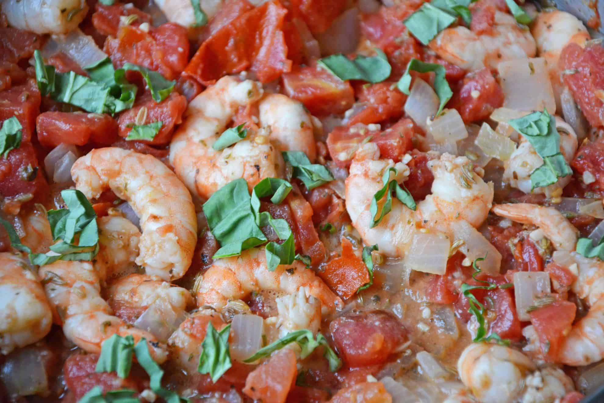 Tomato Basil Shrimp Pasta is an easy and healthy shrimp pasta recipe. It's great for busy weeknights but full of flavor and sure to impress guests! #shrimppasta #shrimpmeals #shrimppastarecipe www.savoryexperiments.com