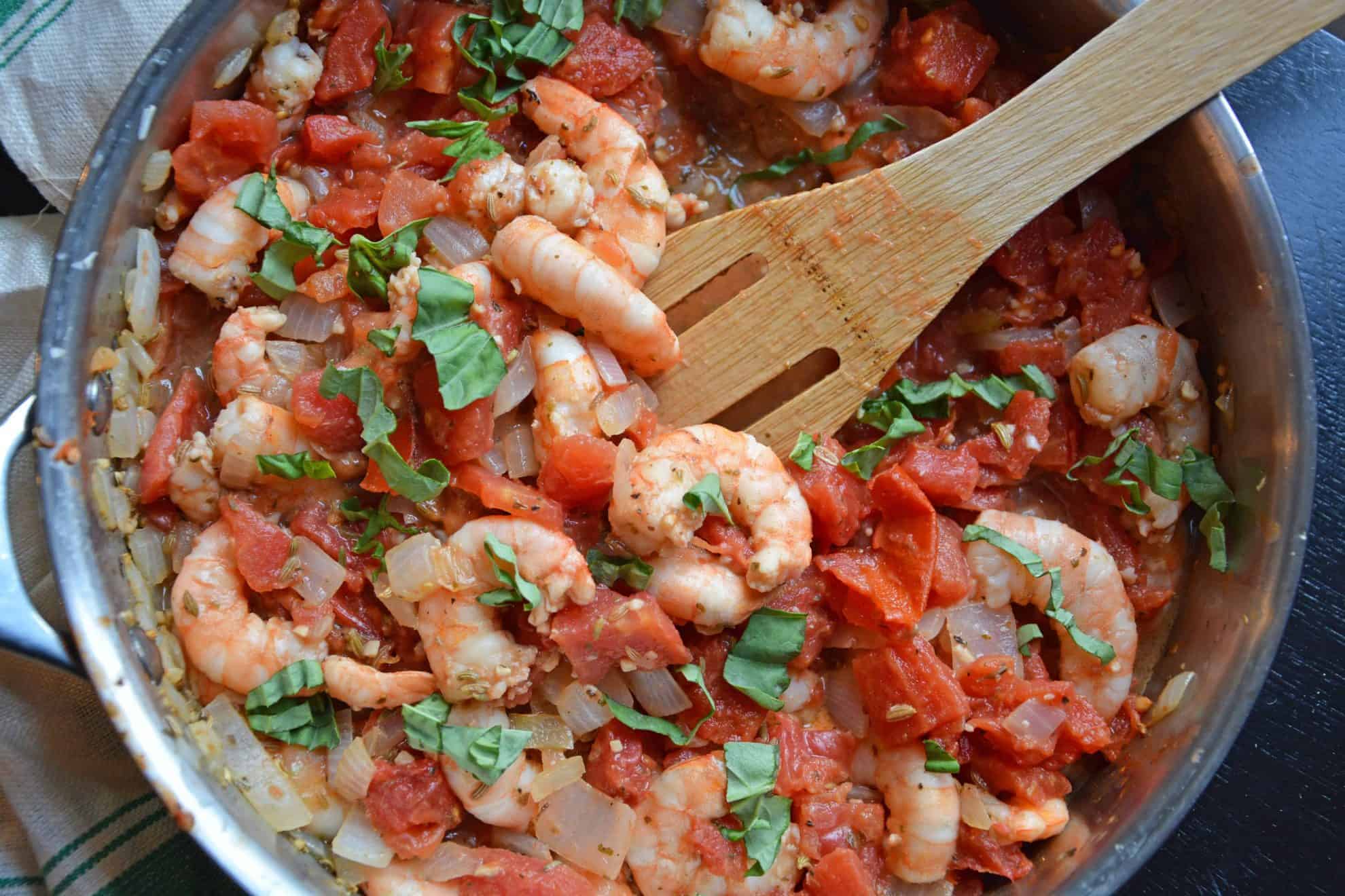 Tomato Basil Shrimp Pasta is an easy and healthy shrimp pasta recipe. It's great for busy weeknights but full of flavor and sure to impress guests! #shrimppasta #shrimpmeals #shrimppastarecipe www.savoryexperiments.com