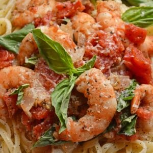 Tomato Basil Shrimp Pasta is an easy and healthy shrimp pasta recipe. It's great for busy weeknights but full of flavor and sure to impress guests! #shrimppasta #shrimpmeals #shrimppastarecipe www.savoryexperiments.com