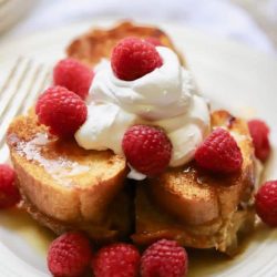 Caramel soaked french toast topped with raspberries