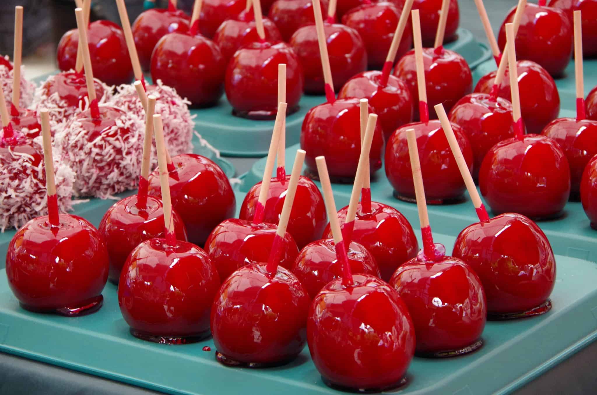 The classic candied apple is a beautifully colorful, glassy red apple. A lollipop candy coating with lush and slightly sour crunchy apple inside. #candiedapples www.savoryexperiments.com