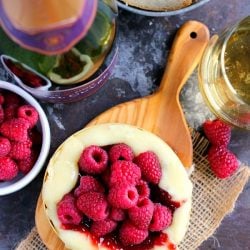 Raspberry baked brie on a wooden board