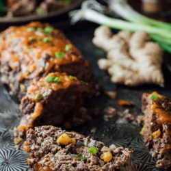 5 spice meatloaf cut into slices on a plate