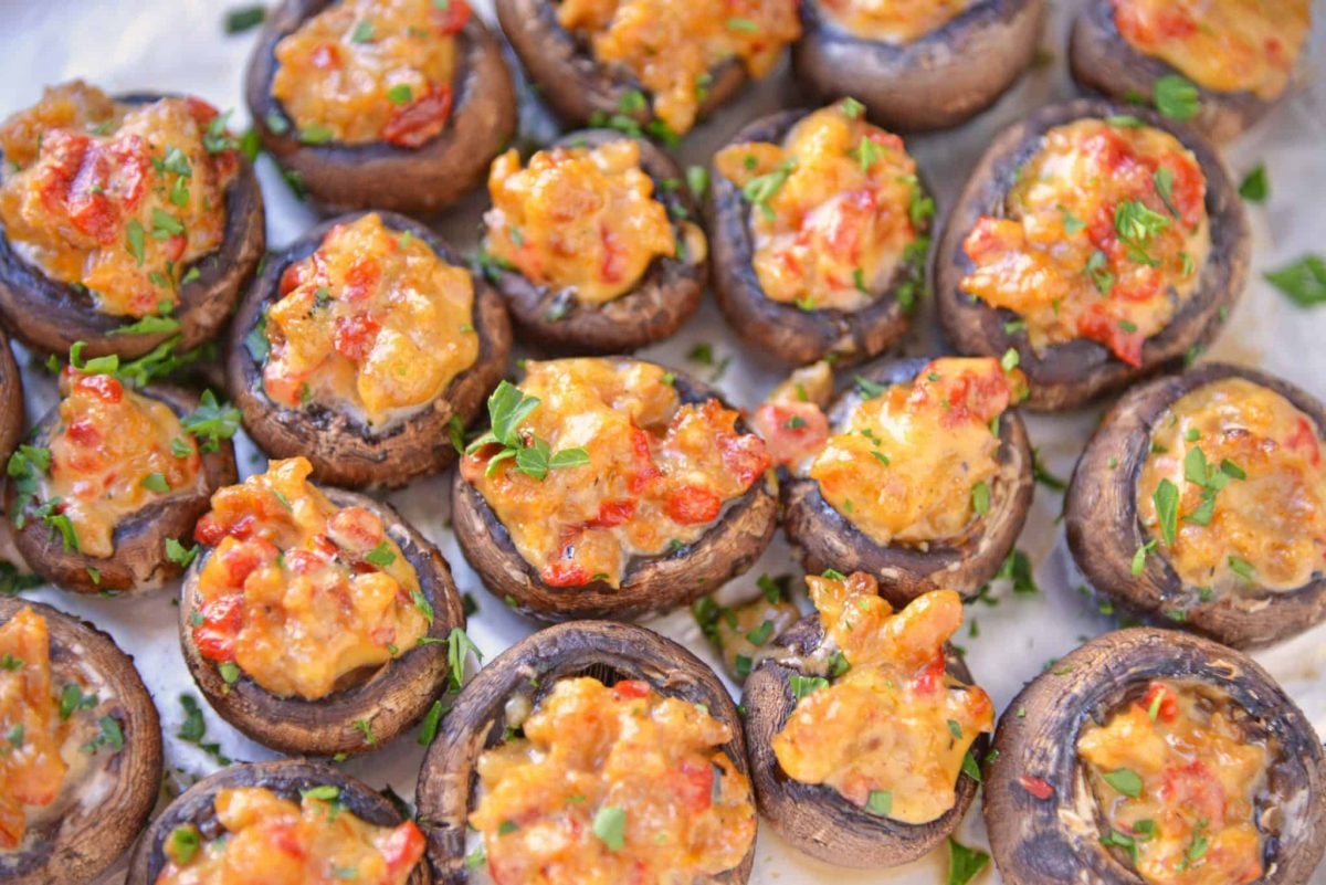 cluster of sausage stuffed mushrooms with red peppers and parsley 