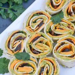 Chipotle cheddar pinwheel recipes on a white tray