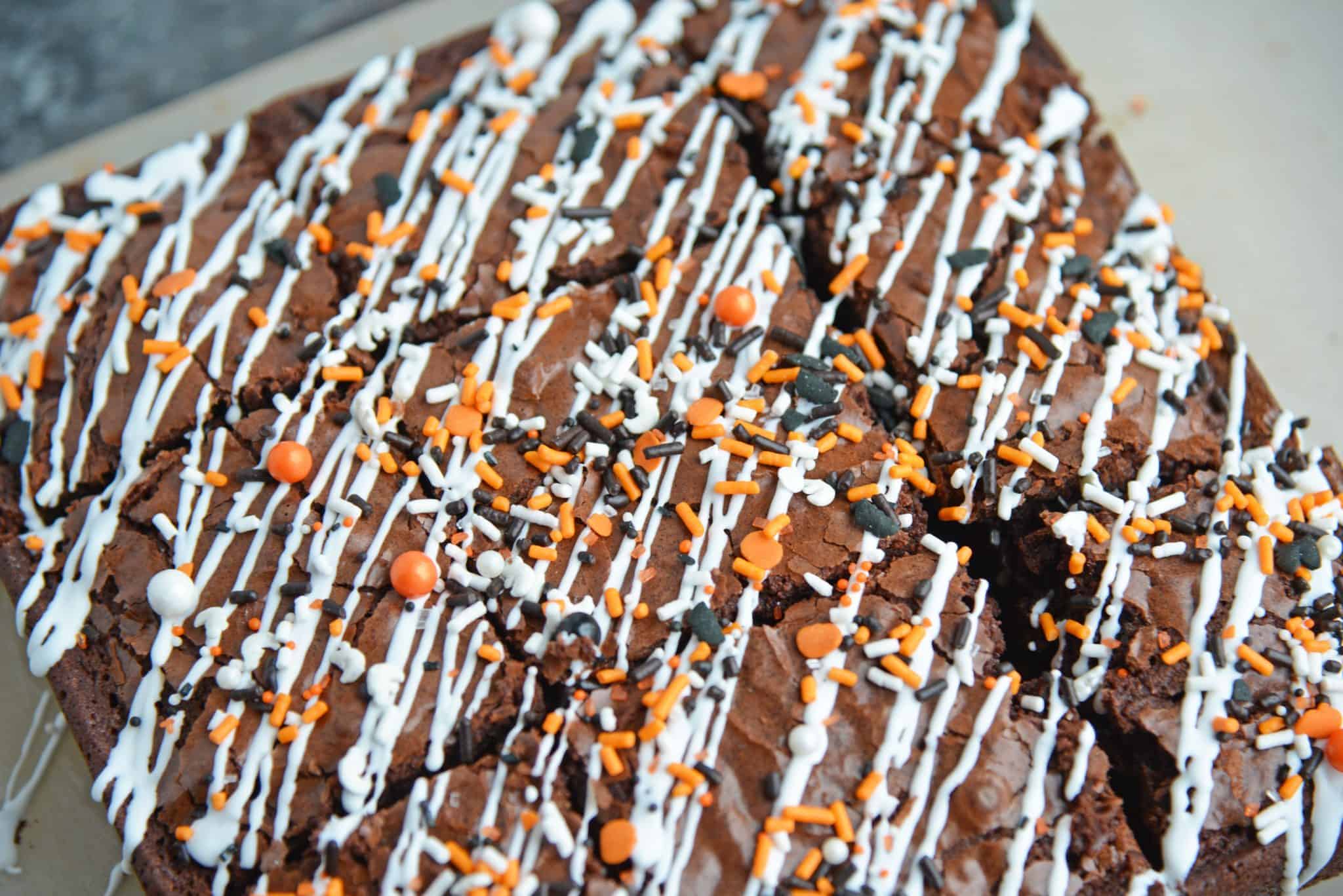 Halloween Brownies are a quick and easy Halloween themed dessert made with box brownie mix, cookie icing and sprinkles. An easy Halloween dessert! #halloweenbrownies #halloweenthemeddesserts #browniemix www.savoryexperiments.com