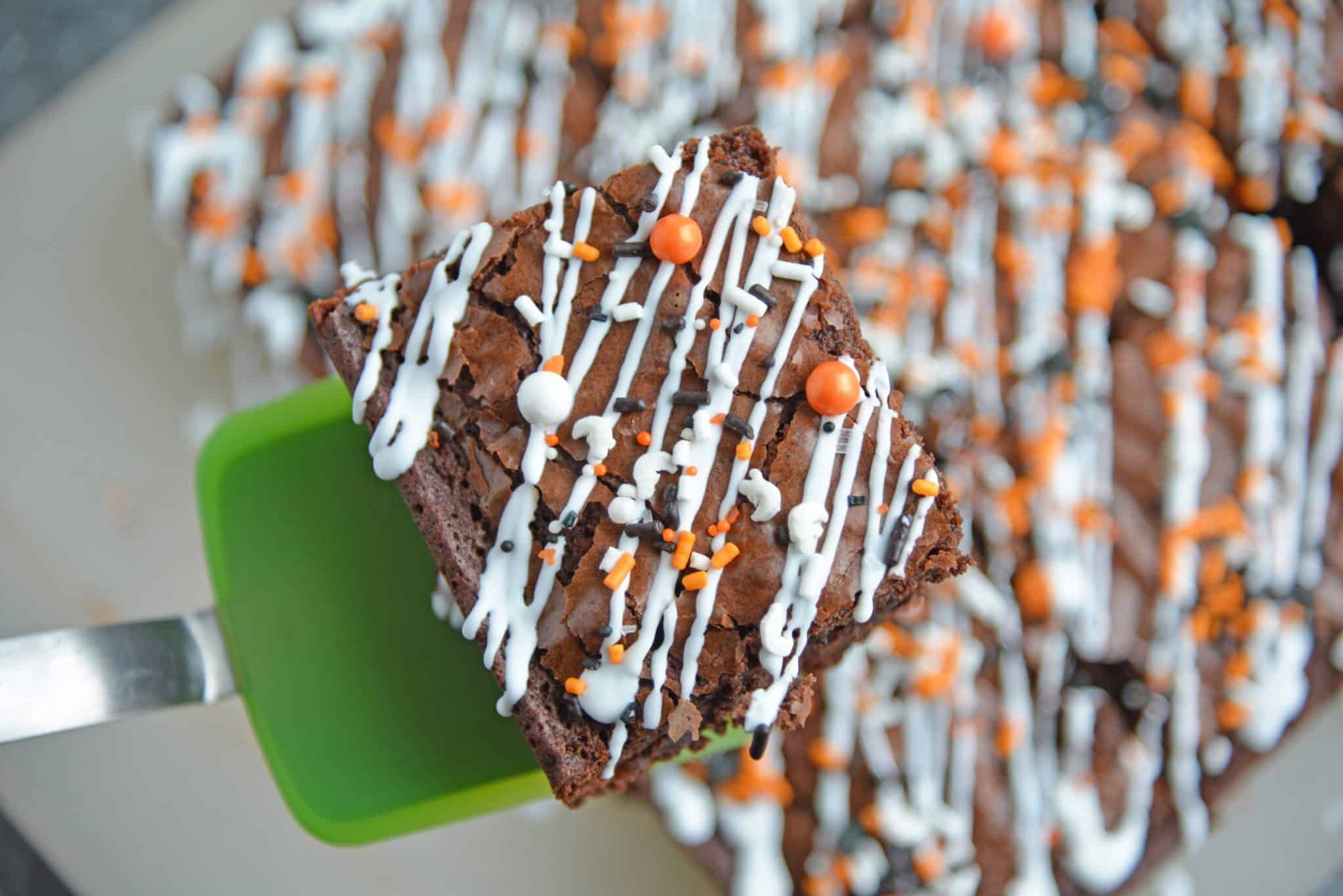 Halloween Brownies are a quick and easy Halloween themed dessert made with box brownie mix, cookie icing and sprinkles. An easy Halloween dessert! #halloweenbrownies #halloweenthemeddesserts #browniemix www.savoryexperiments.com