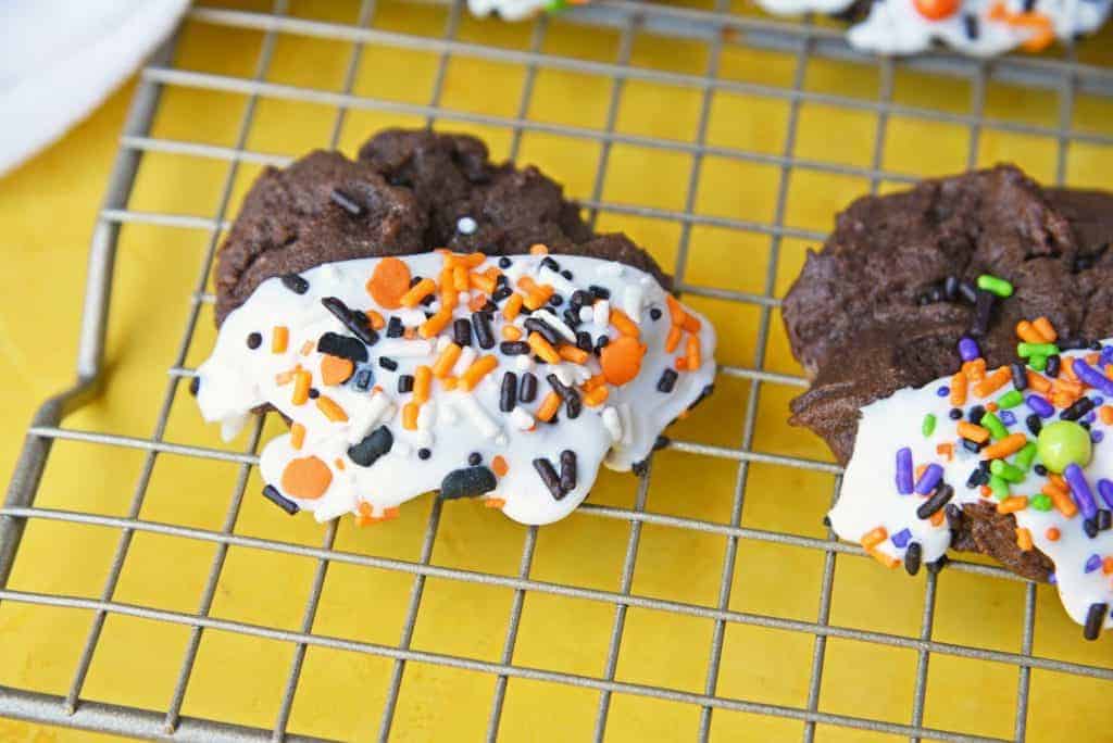 Halloween Chocolate Sugar Cookies combine soft sugar cookies with a delicious chocolate flavor, cookie icing and sprinkles for an easy Halloween dessert! #halloweencookies #chocolatesugarcookies #halloweendesserts www.savoryexperiments.com