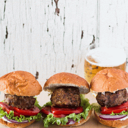 Three meatloaf sliders on wood tray