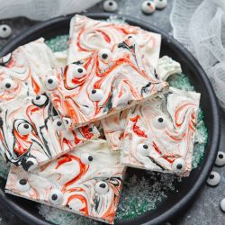 Monster Bark is a quick and easy Halloween treat made with candy eyeballs. Always a hit with kids, it's the perfect Halloween dessert for any party! #monsterbark #howtomakechocolatebark #candyeyeballs www.savoryexperiments.com
