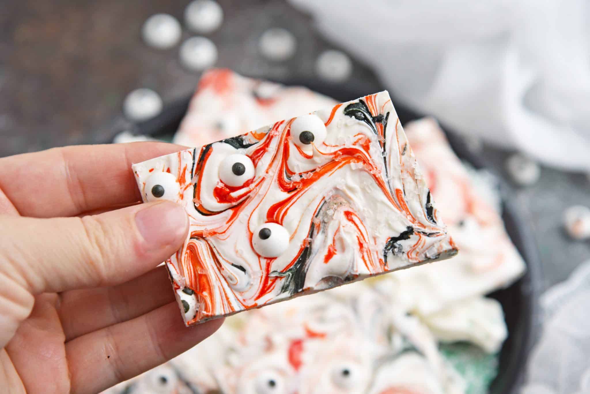 Monster Bark is a quick and easy Halloween treat made with candy eyeballs. Always a hit with kids, it's the perfect Halloween dessert for any party! #monsterbark #howtomakechocolatebark #candyeyeballs www.savoryexperiments.com