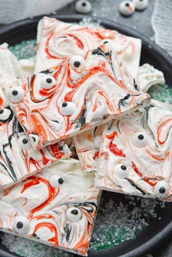 Monster Bark is a quick and easy Halloween treat made with candy eyeballs. Always a hit with kids, it's the perfect Halloween dessert for any party! #monsterbark #howtomakechocolatebark #candyeyeballs www.savoryexperiments.com