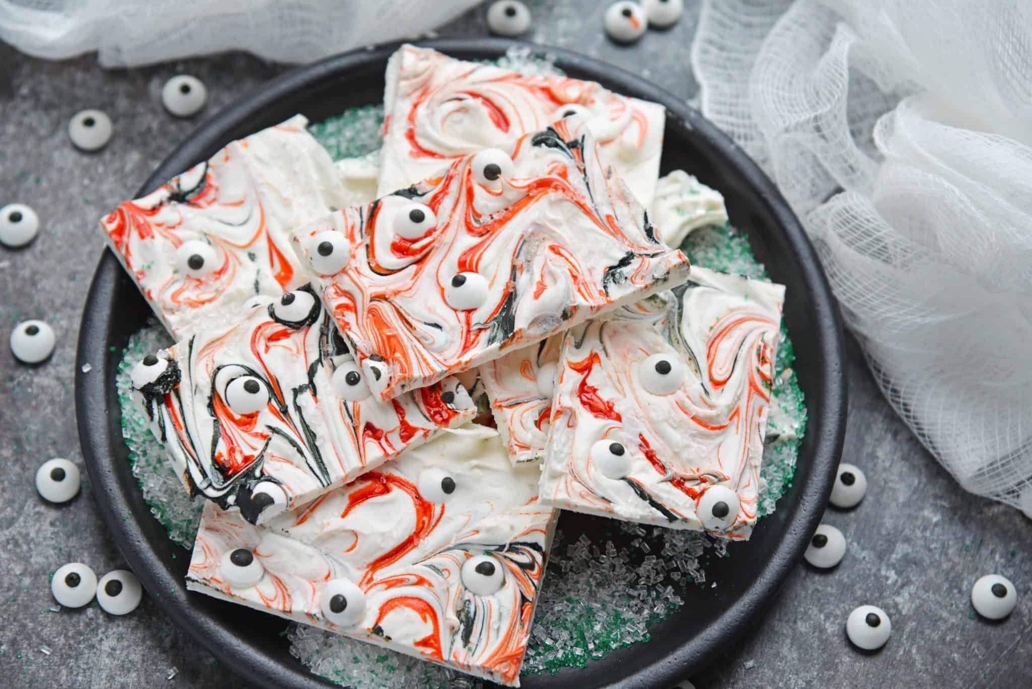 Monster Bark is a quick and easy Halloween treat made with candy eyeballs. Always a hit with kids, it's the perfect Halloween dessert for any party! #monsterbark #howtomakechocolatebark #candyeyeballs www.savoryexperiments.com