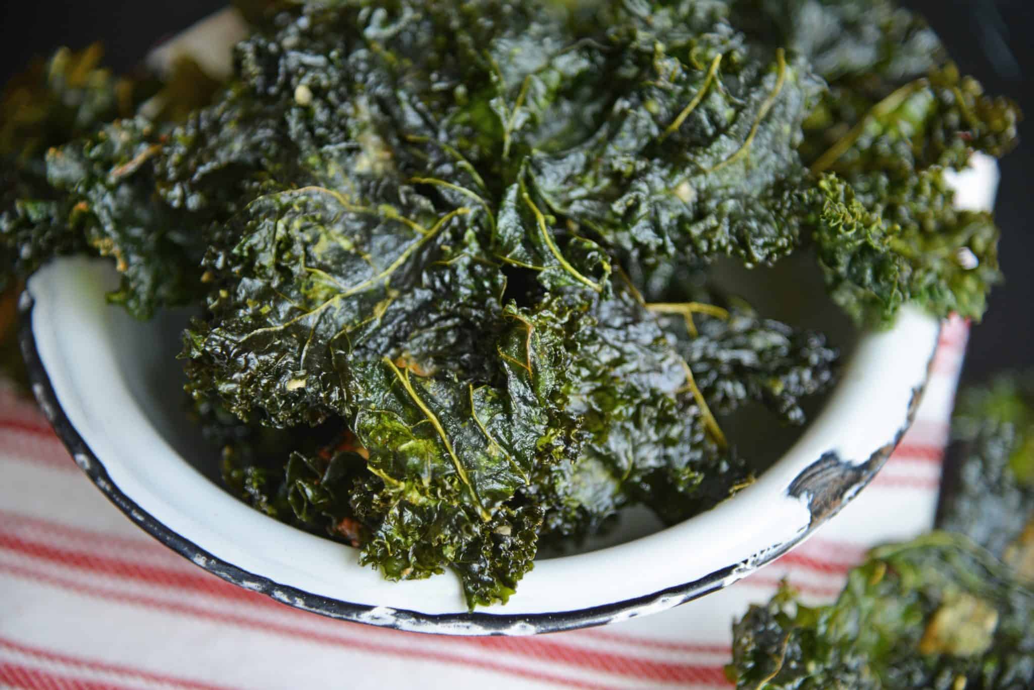 Ranch Kale Chips are a quick and easy 3 ingredient kale chips recipe that offer a tasty and healthy alternative to other chips and snacks. #ranchkalechips #kalechipsrecipe www.savoryexperiments.com