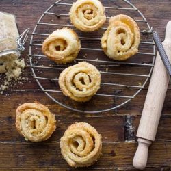 Brown sugar pinwheel recipes on a wire rack with a rolling pin