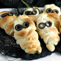 Jalapeno popper mummies on black burlap