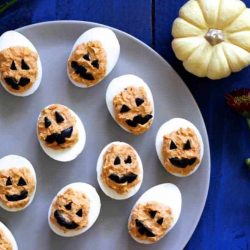 Jack-O-Lantern Deviled Eggs on a tray