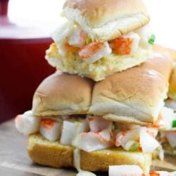 A stack of lobster sliders on a cutting board