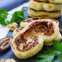 Prosciutto and date pinwheel recipes on top of greens