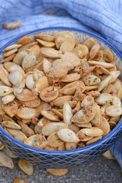 Ranch Pumpkin Seeds take roasted pumpkin seeds to a whole new level. With only 3 ingredients, they're an easy and delicious fall snack! #roastedpumpkinseeds #ranchpumpkinseeds www.savoryexperiments.com