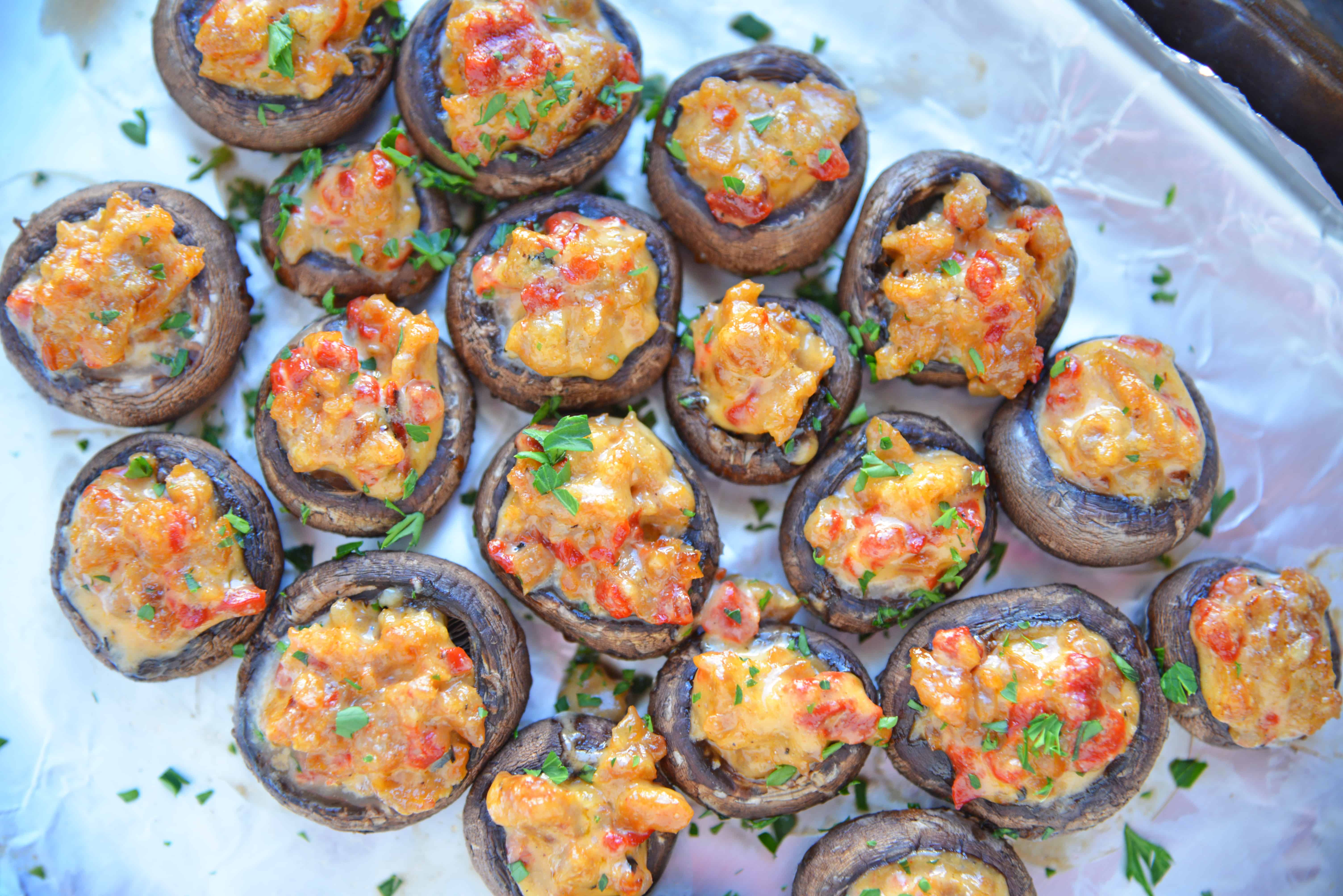 Alfredo Sausage Stuffed Mushrooms are an easy appetizer that's perfect for holiday parties. Everyone will love these stuffed mushrooms with sausage! #sausagestuffedmushrooms #stuffedmushrooms www.savoryexperiments.com