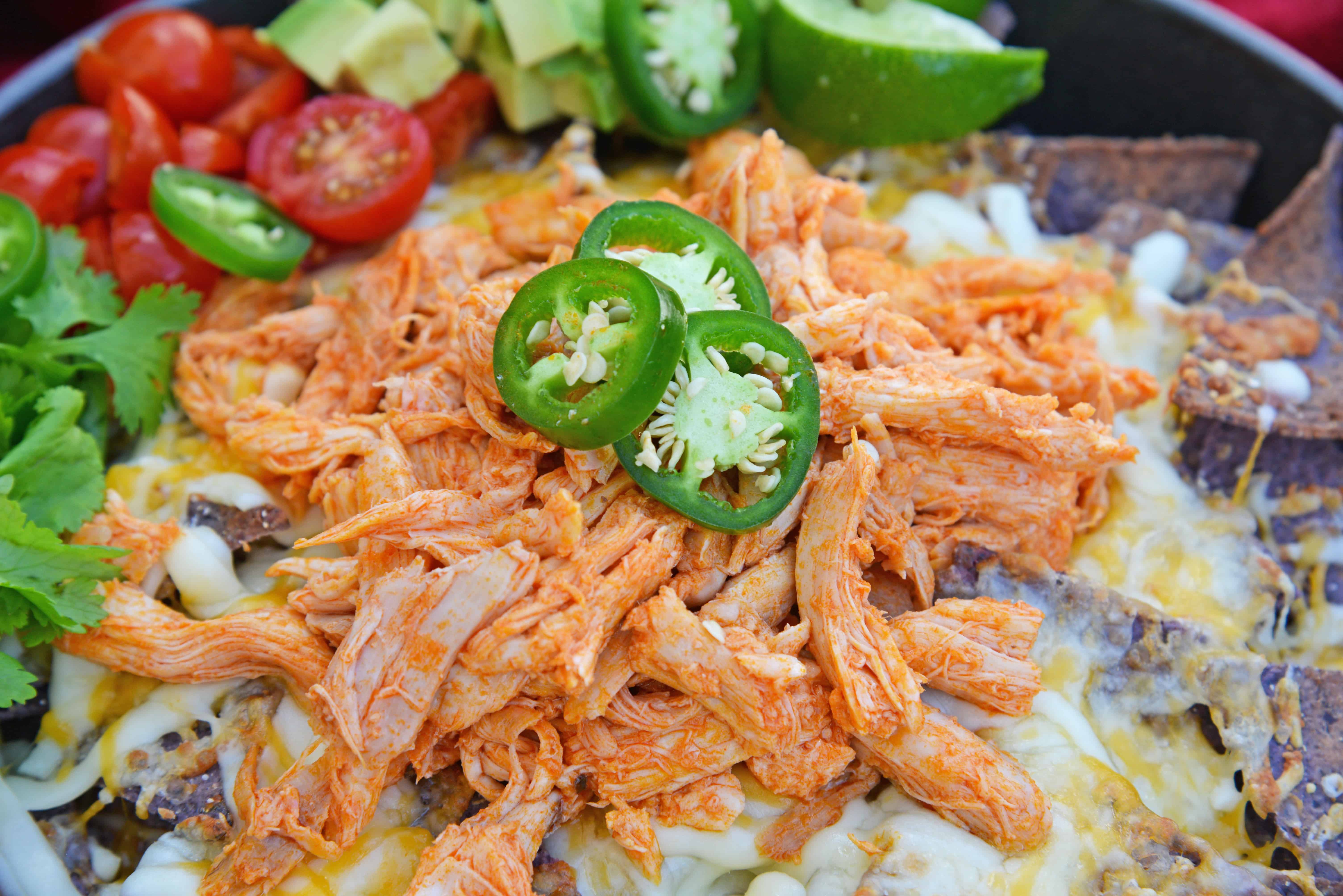 Buffalo Chicken Nachos is an easy nachos recipe that is perfect for a quick Tex Mex meal or game day appetizer. Ready in minutes with few ingredients! #buffalochickennachos #buffalochicken #nachosrecipe www.savoryexperiments.com