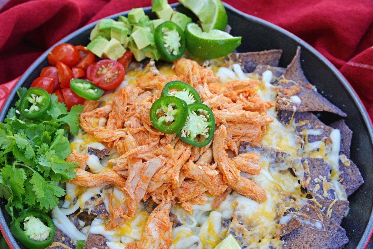 Buffalo Chicken Nachos is an easy nachos recipe that is perfect for a quick Tex Mex meal or game day appetizer. Ready in minutes with few ingredients! #buffalochickennachos #buffalochicken #nachosrecipe www.savoryexperiments.com