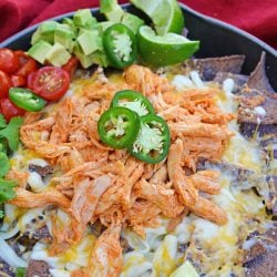 Buffalo Chicken Nachos is an easy nachos recipe that is perfect for a quick Tex Mex meal or game day appetizer. Ready in minutes with few ingredients! #buffalochickennachos #buffalochicken #nachosrecipe www.savoryexperiments.com