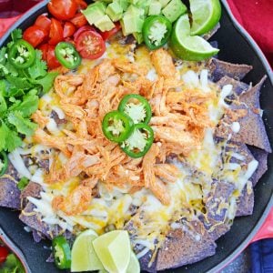 Buffalo Chicken Nachos is an easy nachos recipe that is perfect for a quick Tex Mex meal or game day appetizer. Ready in minutes with few ingredients! #buffalochickennachos #buffalochicken #nachosrecipe www.savoryexperiments.com