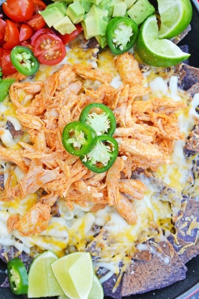 Buffalo Chicken Nachos is an easy nachos recipe that is perfect for a quick Tex Mex meal or game day appetizer. Ready in minutes with few ingredients! #buffalochickennachos #buffalochicken #nachosrecipe www.savoryexperiments.com