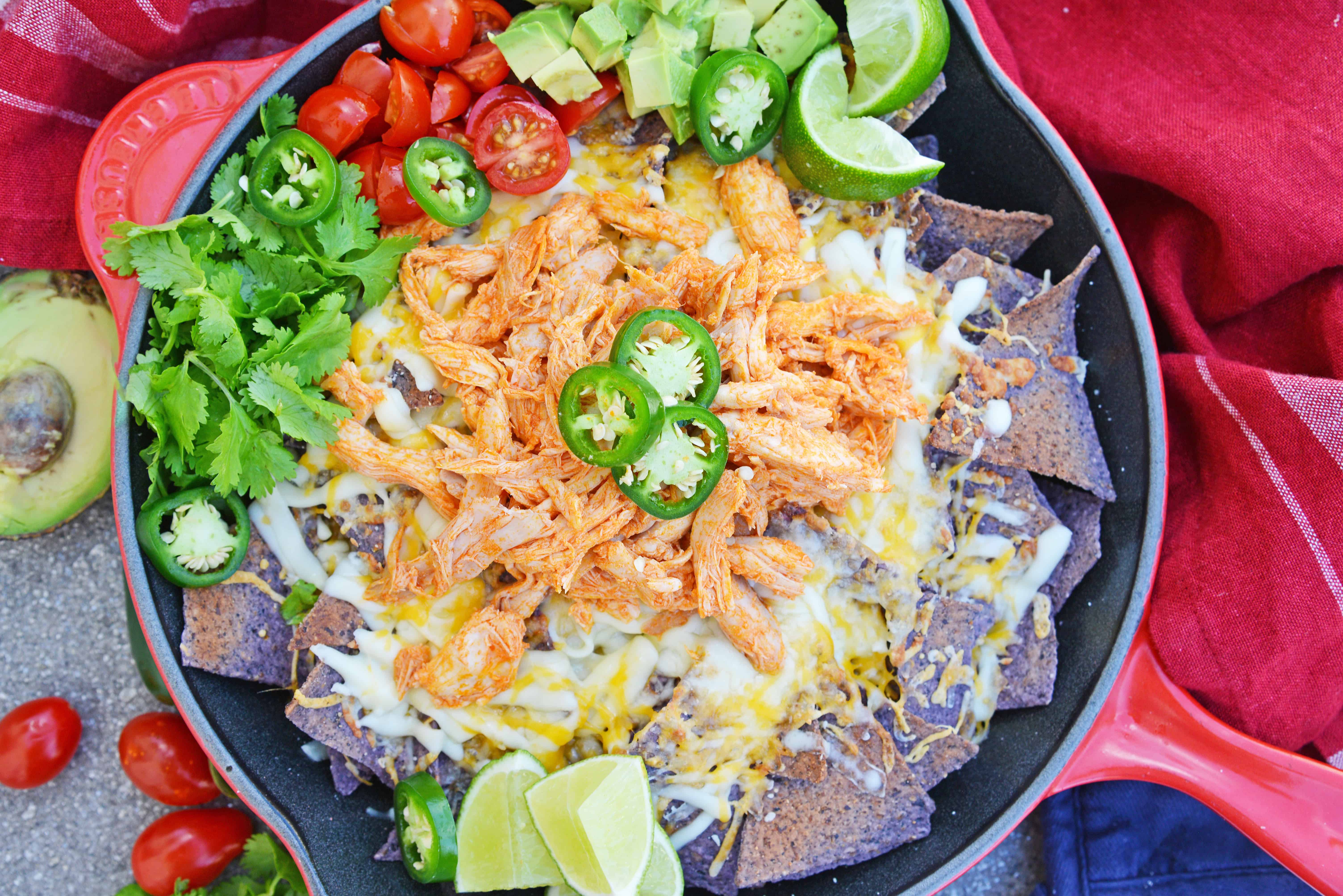 Buffalo Chicken Nachos is an easy nachos recipe that is perfect for a quick Tex Mex meal or game day appetizer. Ready in minutes with few ingredients! #buffalochickennachos #buffalochicken #nachosrecipe www.savoryexperiments.com