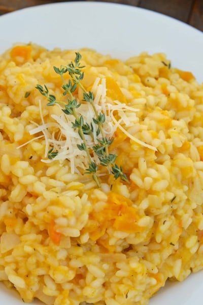 Butternut Squash Risotto is an easy side dish or entrée made with Arborio rice, crisp white cooking wine, sweet roasted butternut squash and fresh thyme. #risottorecipes #butternutsquash www.savoryexperiments.com