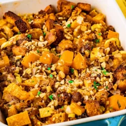 angled shot of butternut squash stuffing in baking dish