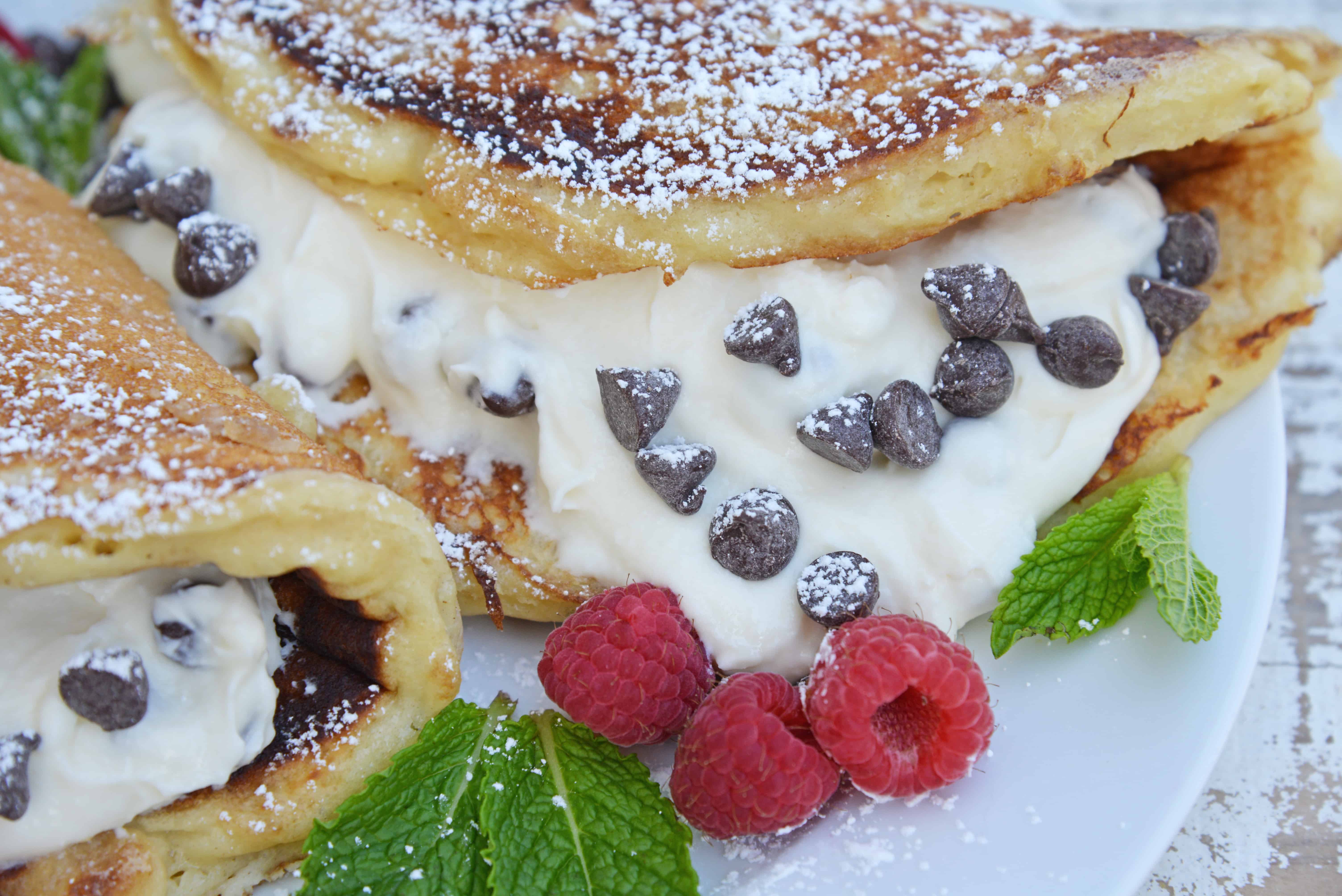 Cannoli Pancakes are stuffed with a rich, delicious cannoli filling. This breakfast cannoli is perfect for special breakfasts and brunches. #cannolipancakes #breakfastcannoli #cannolifilling www.savoryexperiments.com