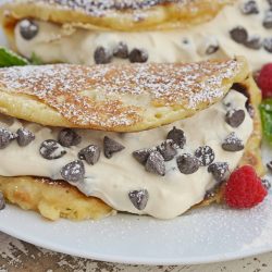 Cannoli Pancakes are stuffed with a rich, delicious cannoli filling. This breakfast cannoli is perfect for special breakfasts and brunches. #cannolipancakes #breakfastcannoli #cannolifilling www.savoryexperiments.com