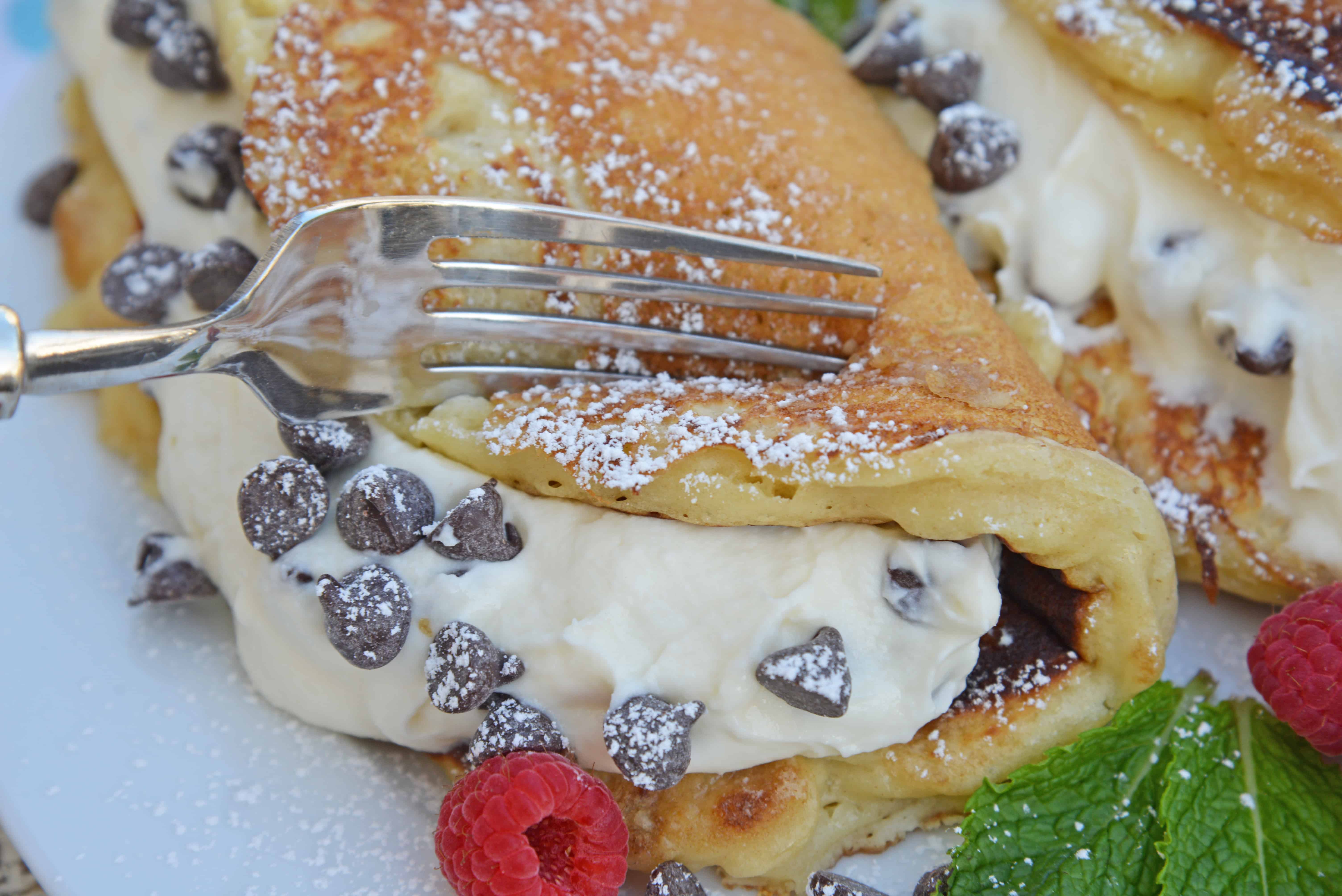 Cannoli Pancakes are stuffed with a rich, delicious cannoli filling. This breakfast cannoli is perfect for special breakfasts and brunches. #cannolipancakes #breakfastcannoli #cannolifilling www.savoryexperiments.com