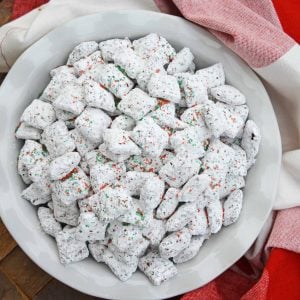 Christmas Puppy Chow transforms a traditional muddy buddy recipe into a festive Reindeer Chow mix! The perfect no-bake dessert for any party or event. #puppychow #reindeerchow #muddybuddy www.savoryexperiments.com