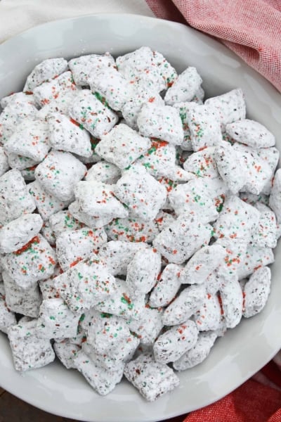 Christmas Puppy Chow transforms a traditional muddy buddy recipe into a festive Reindeer Chow mix! The perfect no-bake dessert for any party or event. #puppychow #reindeerchow #muddybuddy www.savoryexperiments.com